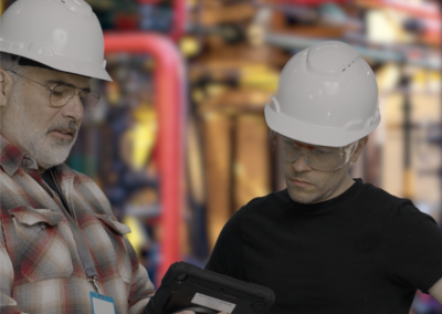 Two factory workers collaborating in a virtual production environment